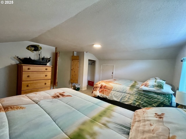 bedroom with carpet, vaulted ceiling, and a textured ceiling