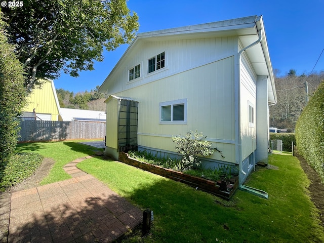 back of house with a yard, a patio, and fence