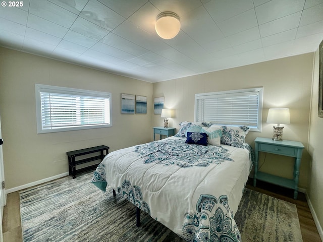 bedroom with baseboards and wood finished floors