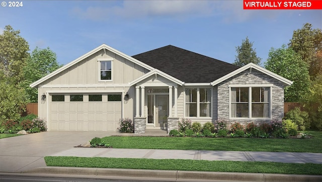 craftsman-style house featuring a front yard and a garage