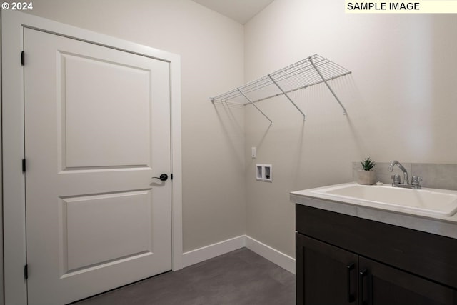 clothes washing area with cabinets, sink, and hookup for a washing machine