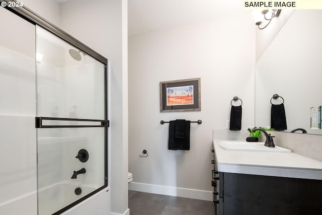 full bathroom with vanity, toilet, and enclosed tub / shower combo