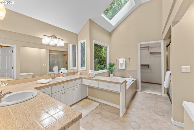 1739 Palisades Terrace Dr, Lake Oswego, OR 97034 - bathroom featuring a stall shower, a skylight, double vanity, a spacious closet, and high vaulted ceiling