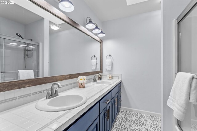 1739 Palisades Terrace Dr, Lake Oswego, OR 97034 - full bath with double vanity, a shower stall, baseboards, tasteful backsplash, and a skylight