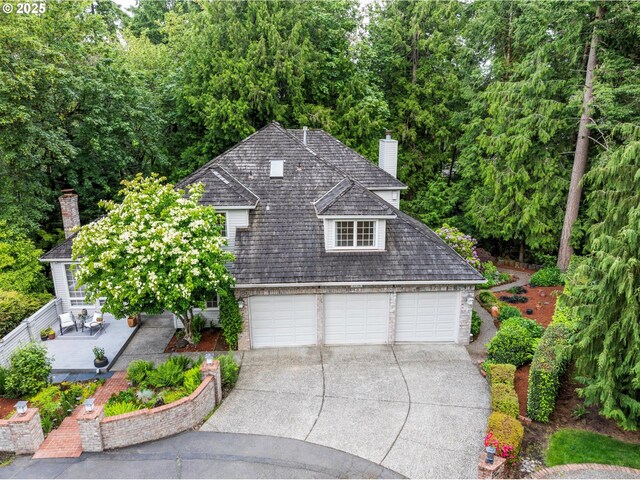 1739 Palisades Terrace Dr, Lake Oswego, OR 97034 - view of front facade featuring a garage, driveway, and a chimney