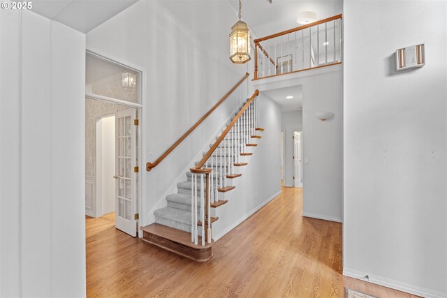 1739 Palisades Terrace Dr, Lake Oswego, OR 97034 - stairs with wood finished floors, a high ceiling, and baseboards