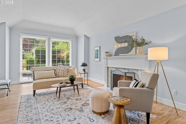 1739 Palisades Terrace Dr, Lake Oswego, OR 97034 - living room with lofted ceiling, baseboards, wood finished floors, and a premium fireplace