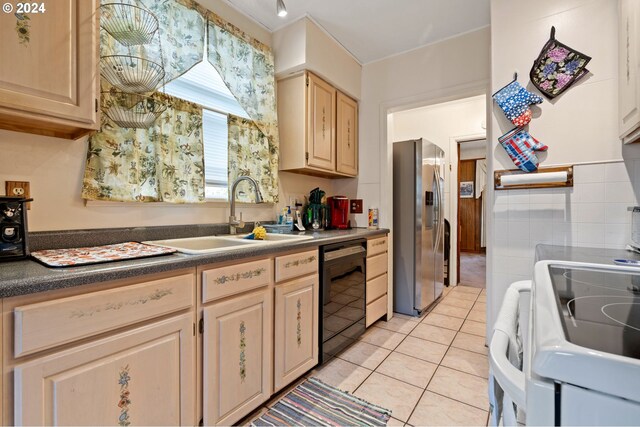 kitchen featuring light brown cabinets, dishwasher, light tile patterned floors, stainless steel refrigerator with ice dispenser, and sink