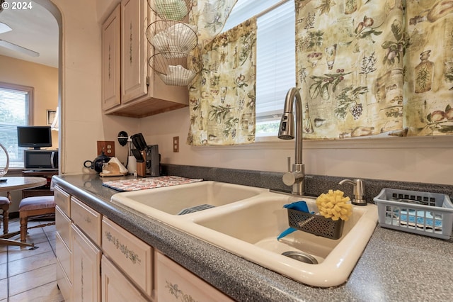 kitchen with sink, light tile patterned floors, and light brown cabinets