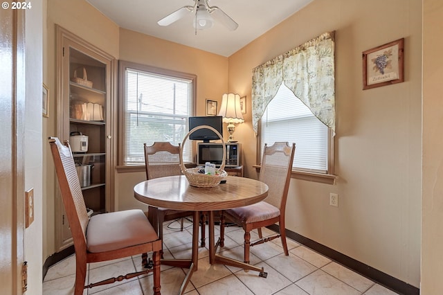 tiled dining space with ceiling fan