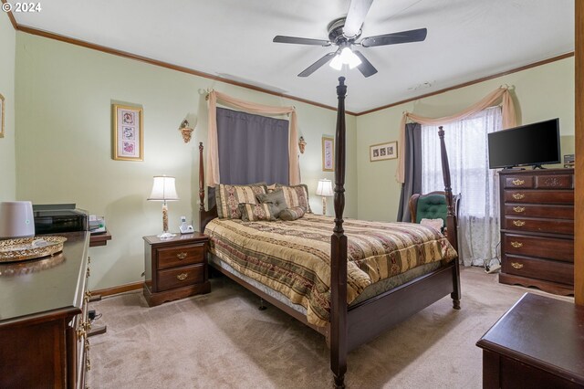 carpeted bedroom with crown molding and ceiling fan