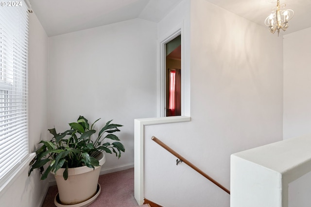 interior space featuring lofted ceiling, a chandelier, carpet flooring, and a wealth of natural light