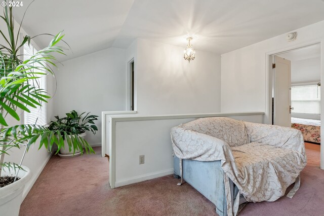 sitting room featuring carpet and lofted ceiling