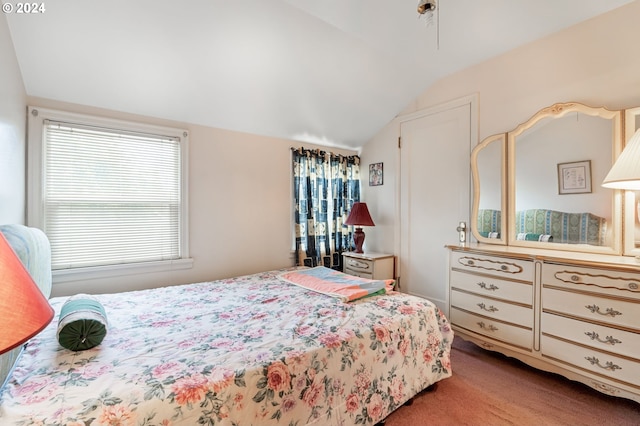 bedroom with light colored carpet and vaulted ceiling