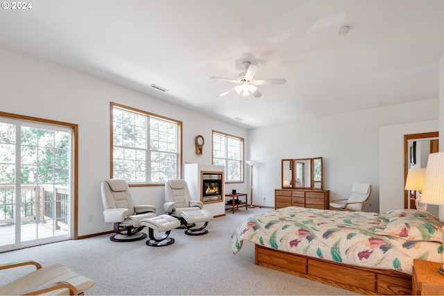 carpeted bedroom with ceiling fan and access to exterior