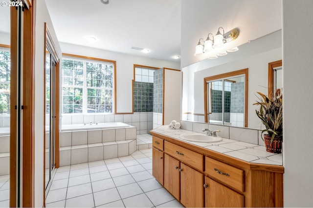 bathroom featuring shower with separate bathtub, tile patterned flooring, and vanity