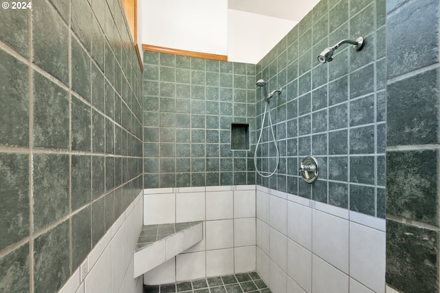 bathroom with tile walls and a tile shower