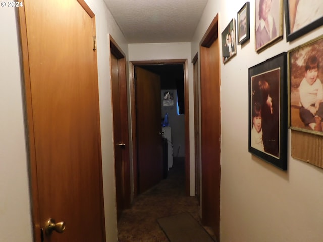 hallway featuring dark tile patterned flooring