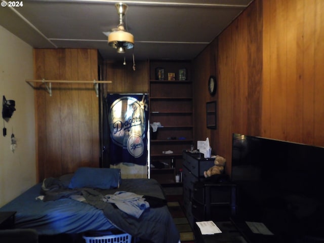 bedroom featuring wood walls