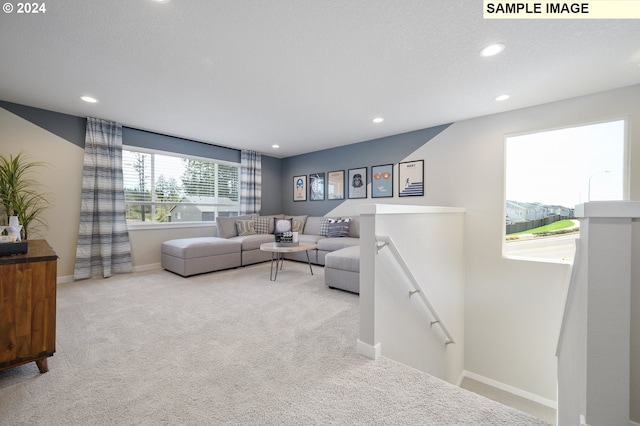 living room with light carpet and a textured ceiling