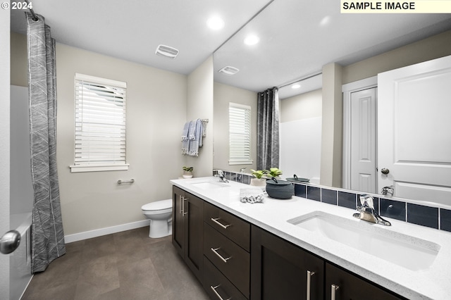 full bathroom featuring vanity, shower / tub combo, and toilet