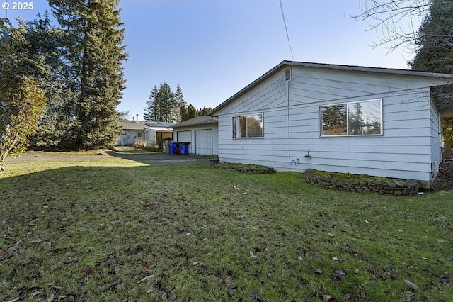 view of home's exterior with a yard and a garage