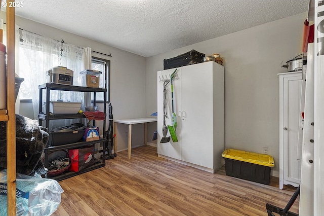 misc room with hardwood / wood-style floors and a textured ceiling