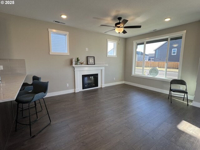 kitchen featuring decorative backsplash, a wealth of natural light, light hardwood / wood-style flooring, and white cabinets