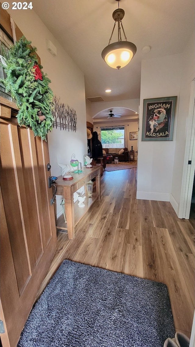 hallway with hardwood / wood-style floors