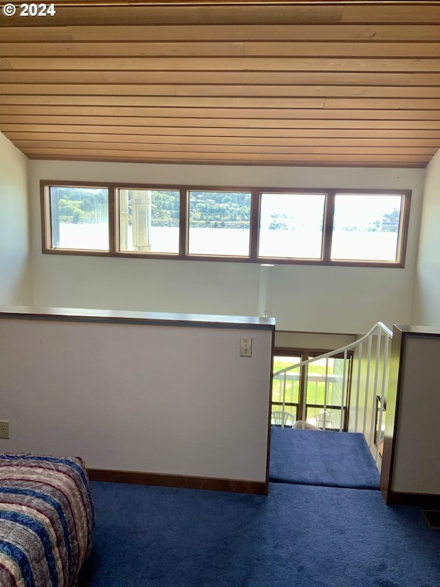 unfurnished bedroom with vaulted ceiling, carpet, wooden ceiling, and baseboards