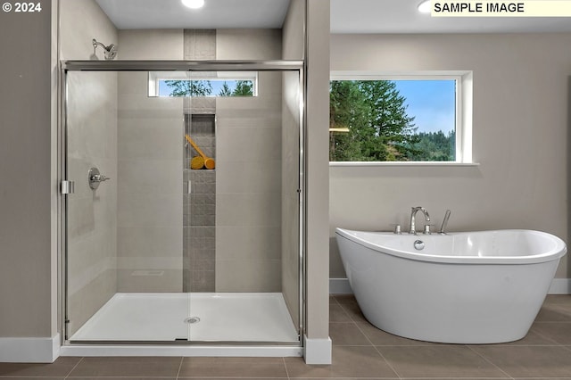 bathroom featuring tile patterned floors, plenty of natural light, and shower with separate bathtub