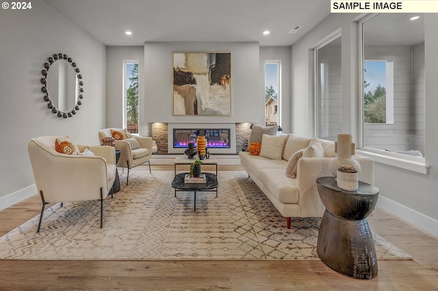 sitting room featuring hardwood / wood-style floors and plenty of natural light