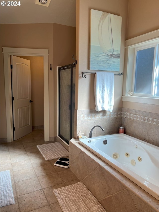 bathroom featuring shower with separate bathtub