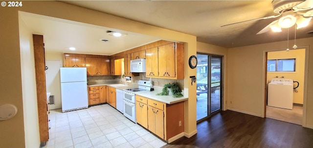 kitchen featuring decorative backsplash, white appliances, ceiling fan, washer / dryer, and light hardwood / wood-style floors