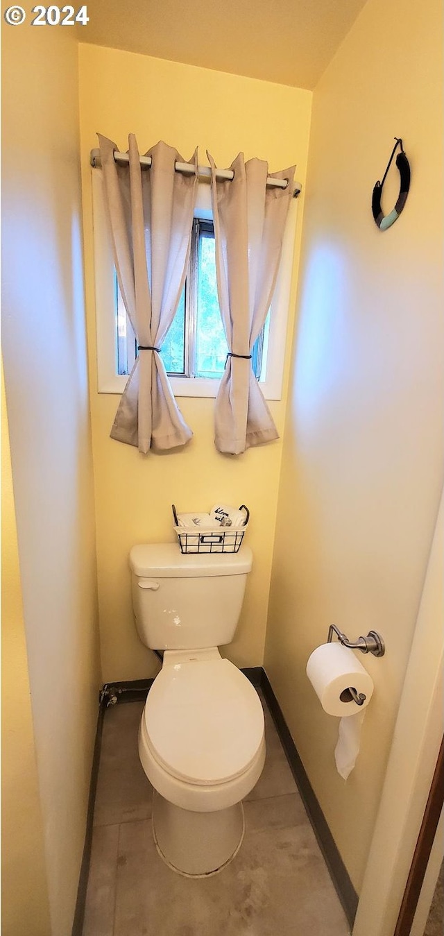 bathroom featuring tile patterned flooring and toilet