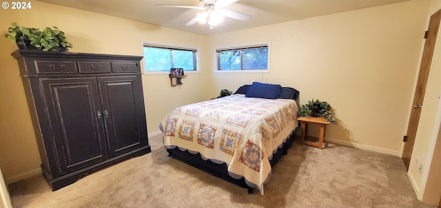 bedroom with light carpet and ceiling fan