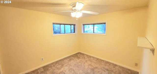 carpeted spare room with ceiling fan