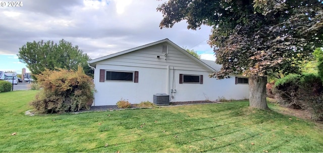 back of property featuring a yard and central AC unit