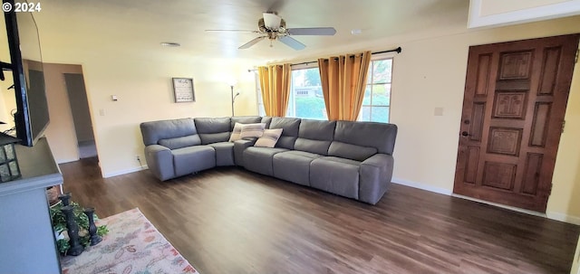 living room with ceiling fan and dark hardwood / wood-style flooring