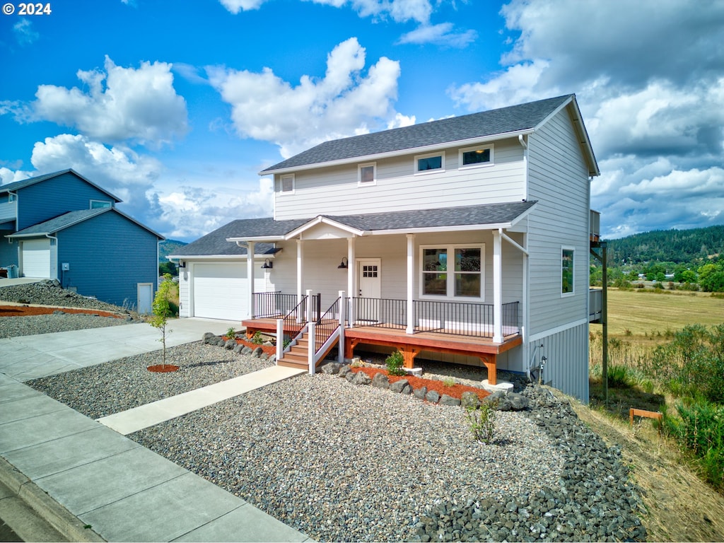 view of front of property featuring covered porch and a garage