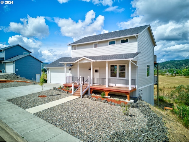 view of front of property featuring covered porch and a garage