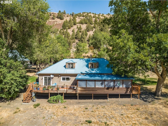 back of house featuring a wooden deck