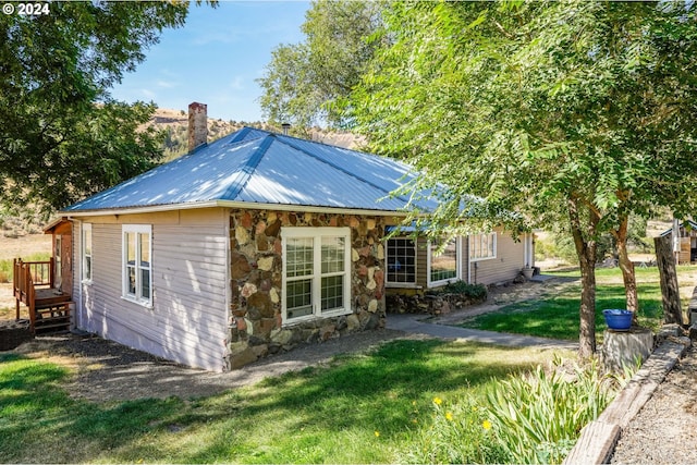 view of home's exterior with a yard