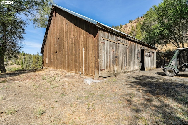 view of property exterior with an outbuilding