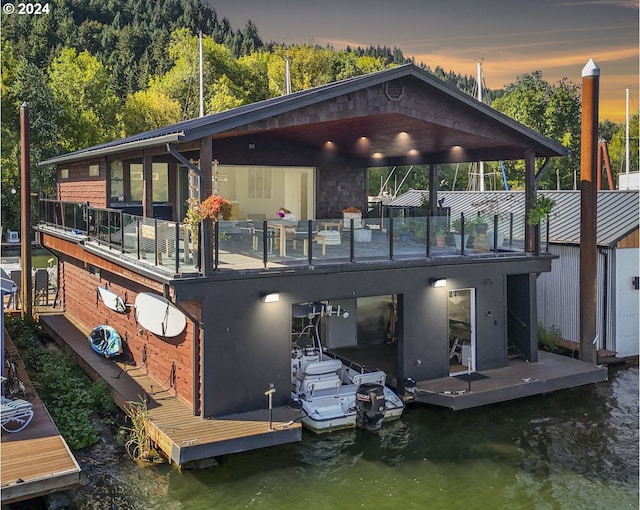 back house at dusk featuring a water view