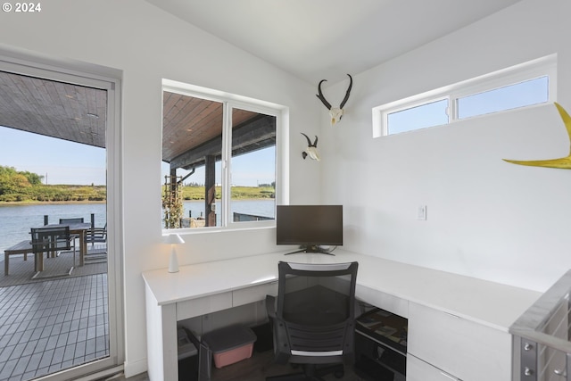 office area featuring plenty of natural light, vaulted ceiling, and a water view