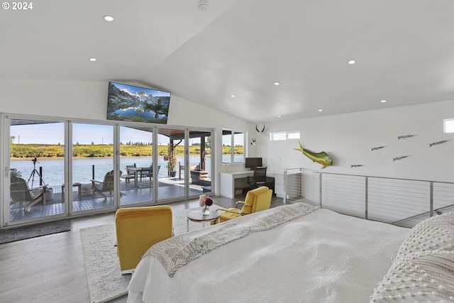 bedroom with vaulted ceiling, multiple windows, hardwood / wood-style flooring, and access to outside