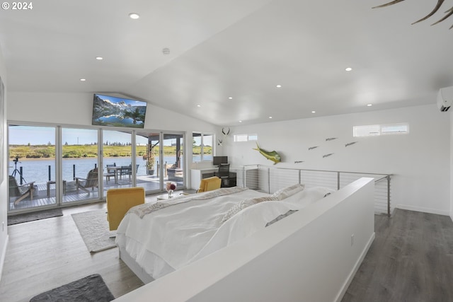 interior space with lofted ceiling, hardwood / wood-style floors, and a healthy amount of sunlight