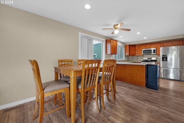 dining room featuring dark wood-type flooring and ceiling fan