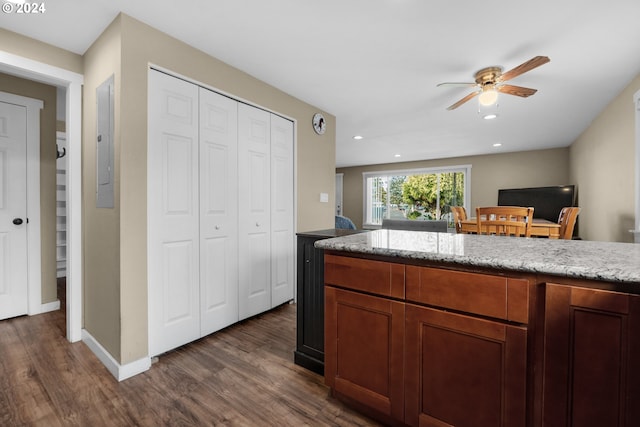 kitchen with ceiling fan, electric panel, dark hardwood / wood-style floors, and light stone counters